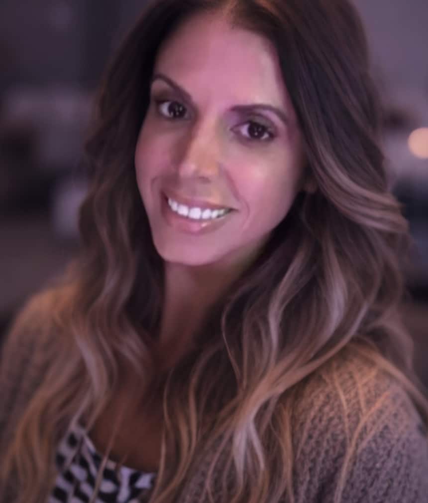 Photo of owner - brown hair with blonde highlights, brown sweater and black and white top. Brown eyes, long hair.